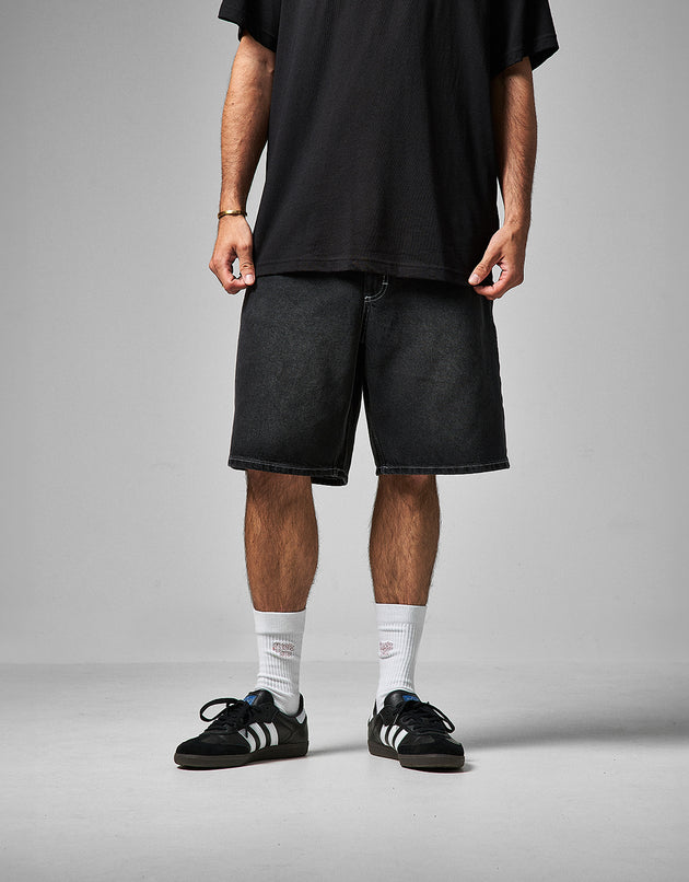 A model from the waist down wearing black washed denim shorts called Route One Super Baggy Jorts. On point with current trends. A baggy loose fit